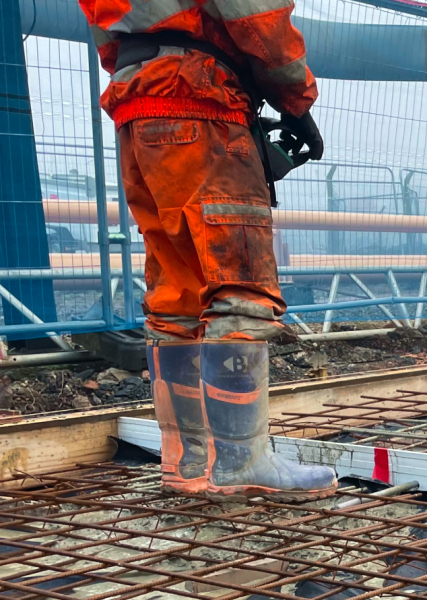 Man wearing orange protective equipment on a construction site