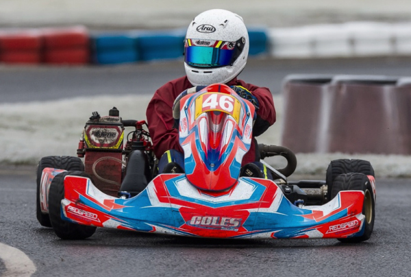 Ellis Bell with Coles Racing, one of our sponsored partners. A man in a helmet racing in a go-kart